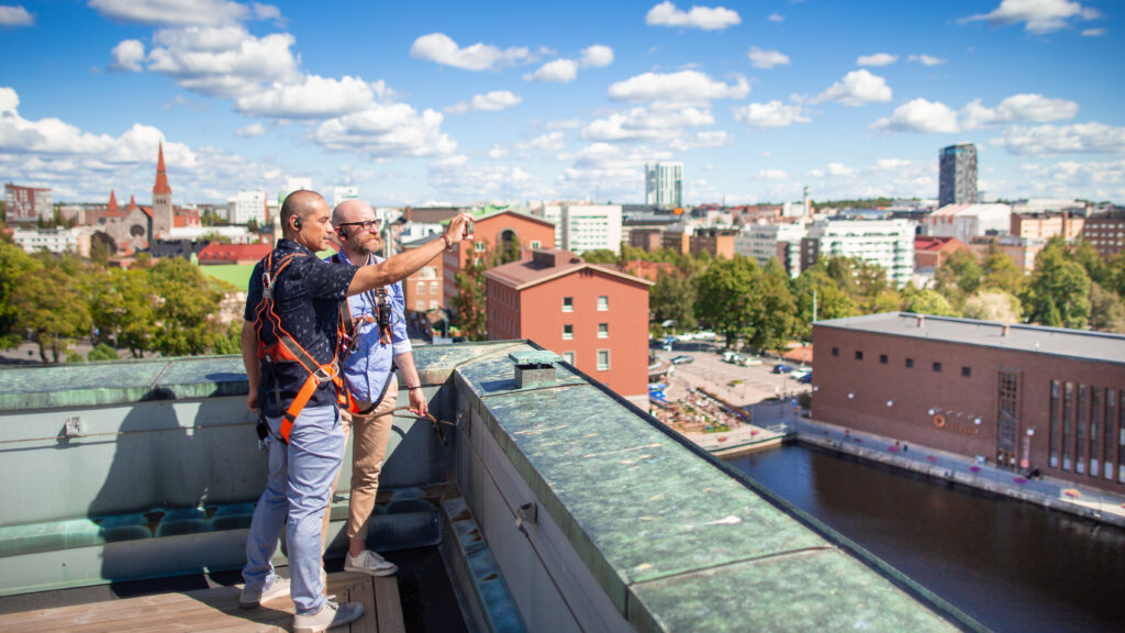 Two people observing the city center at a panorama deck.